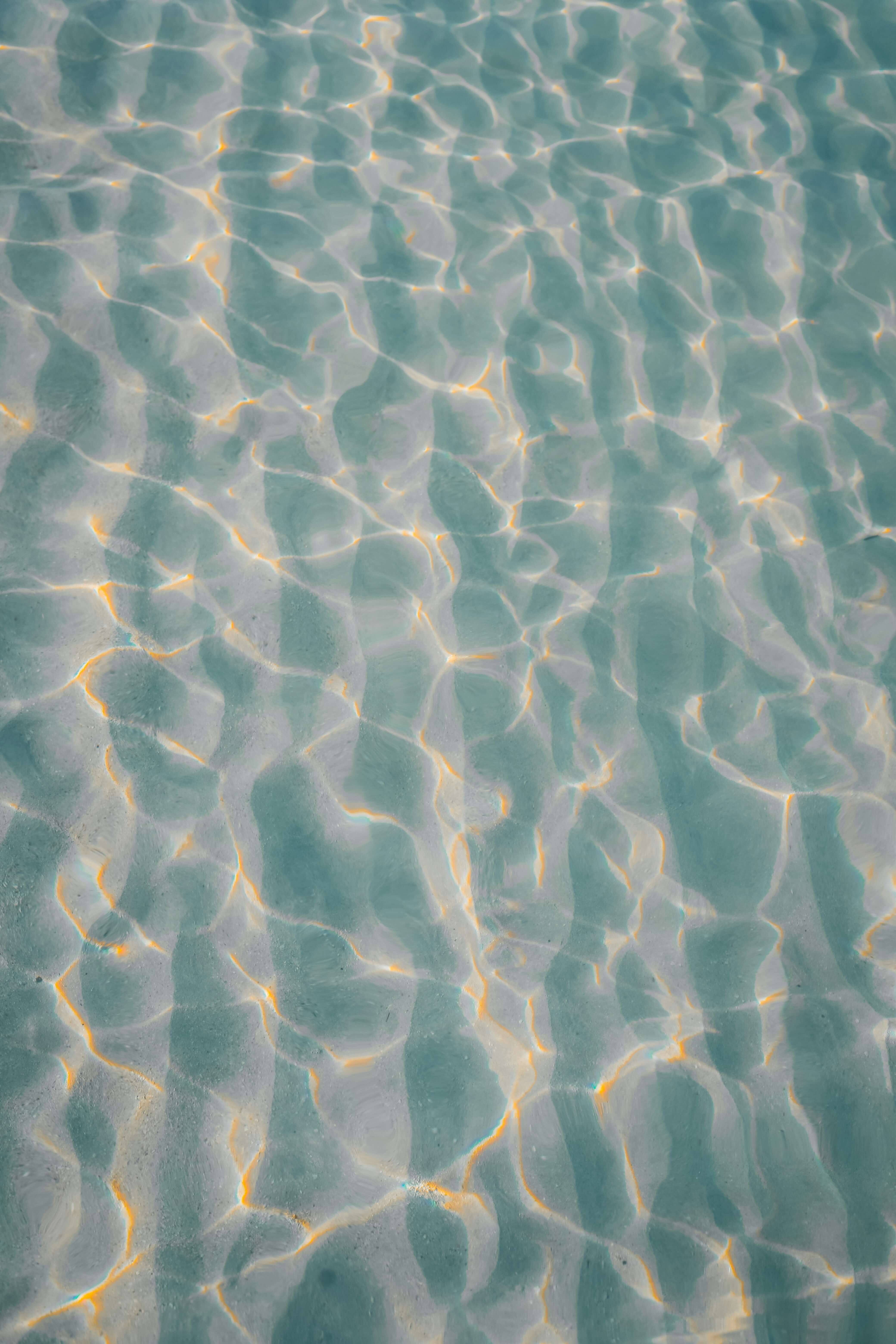 a photo of a texture of water illuminated by a slighty warm light