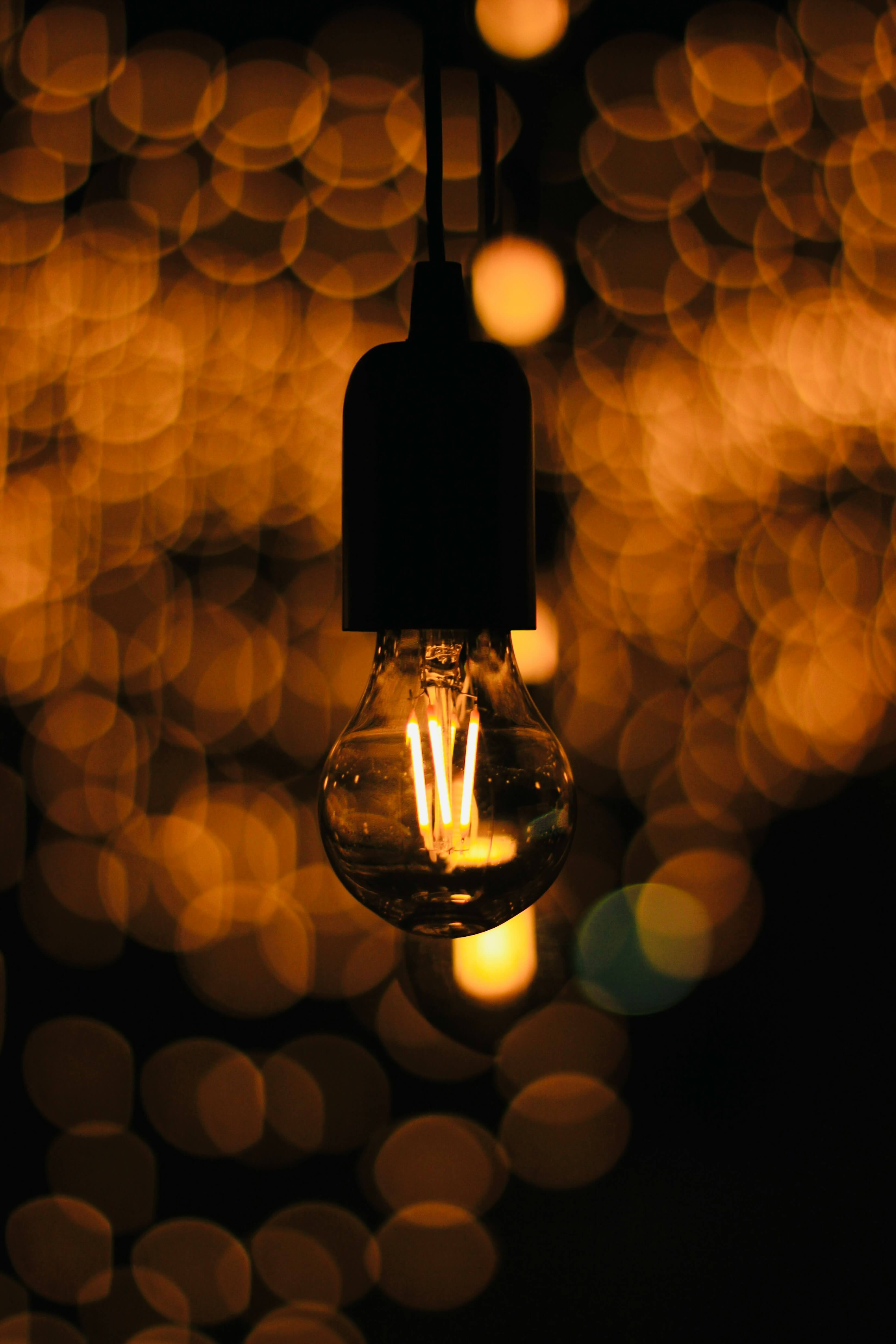 a photo of an orange light bulb with a blurred orange background