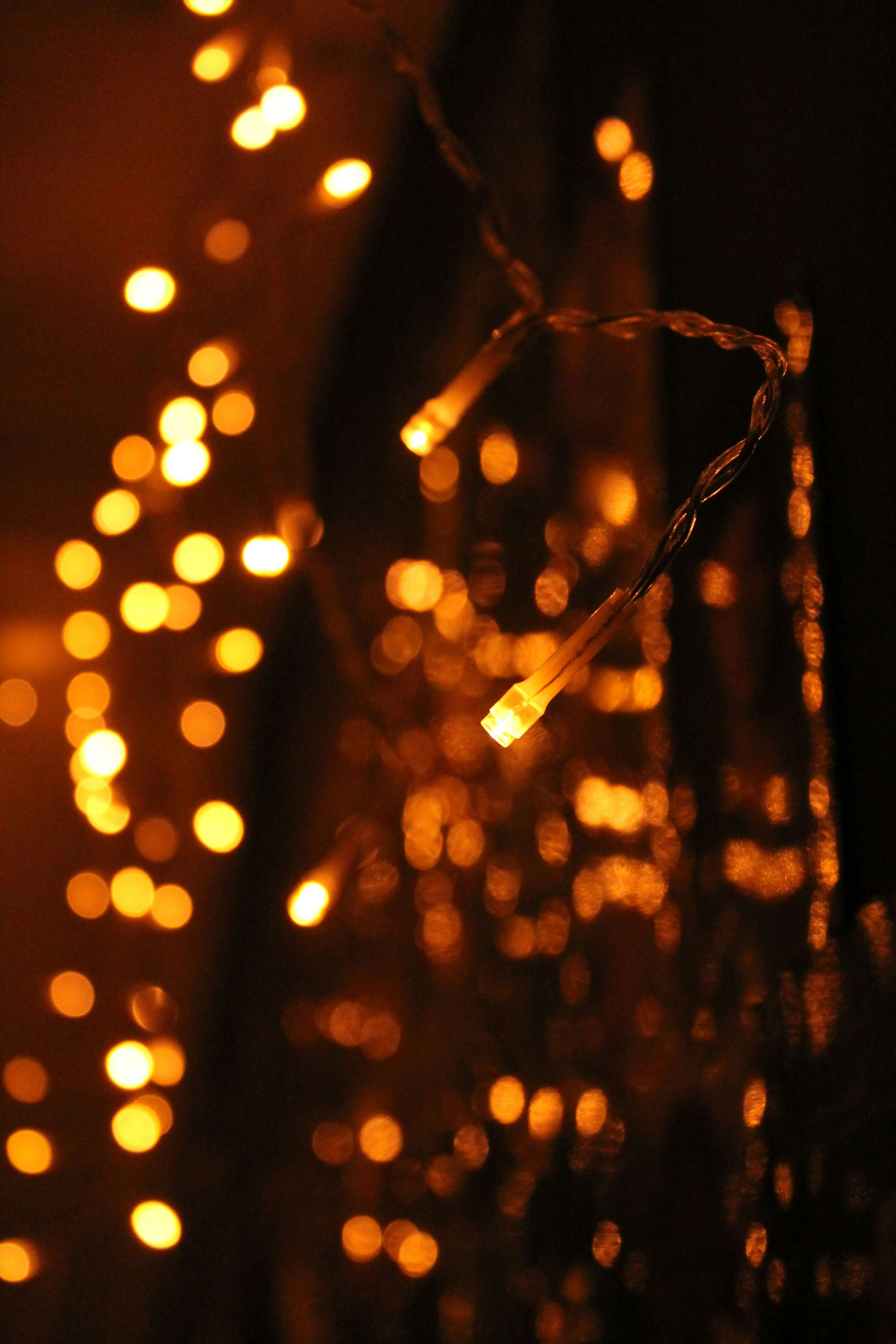 a photo of small warm fairy lights with a few in focus