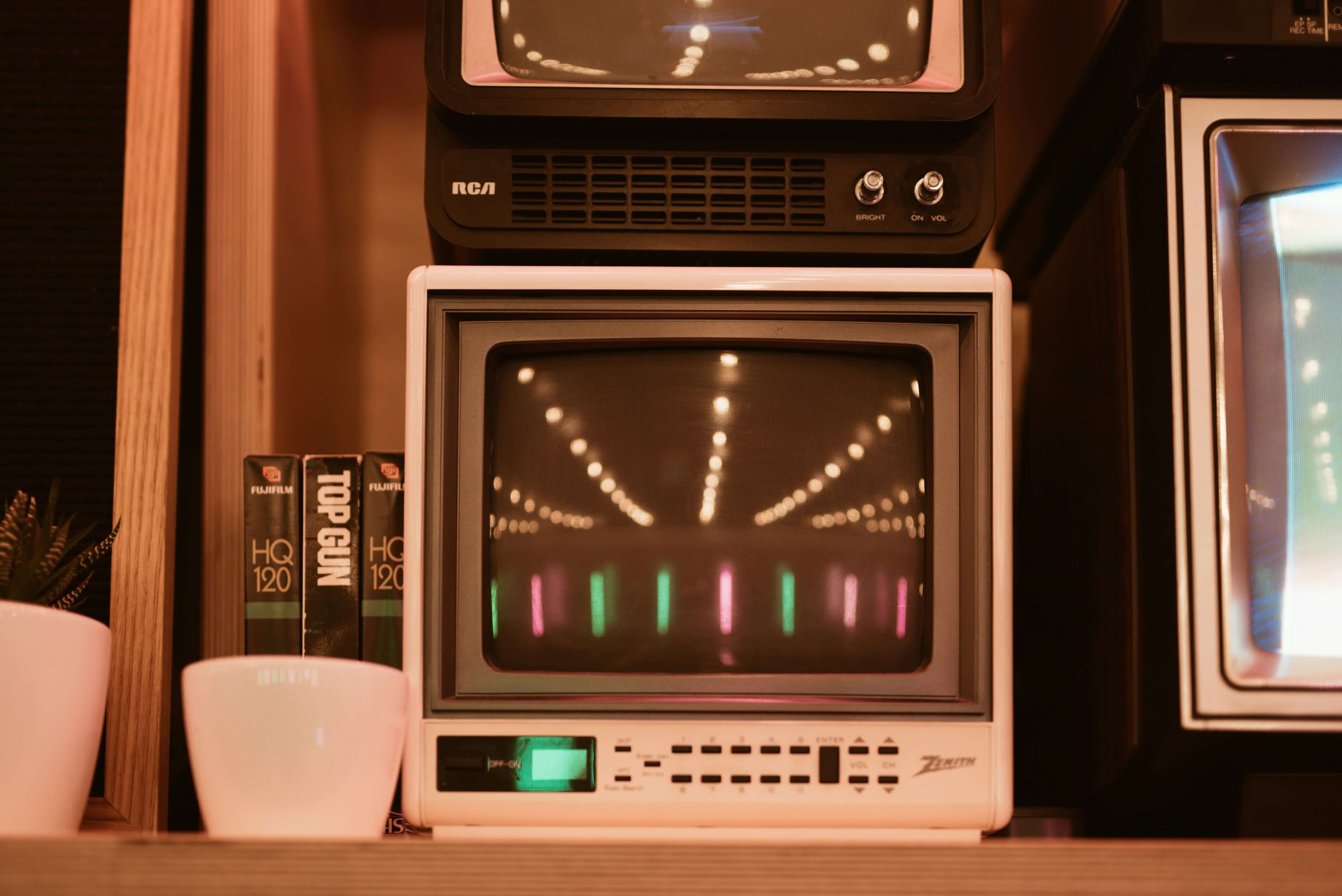 a photo  a CRT displaying various colorful lights in a warmly lit room