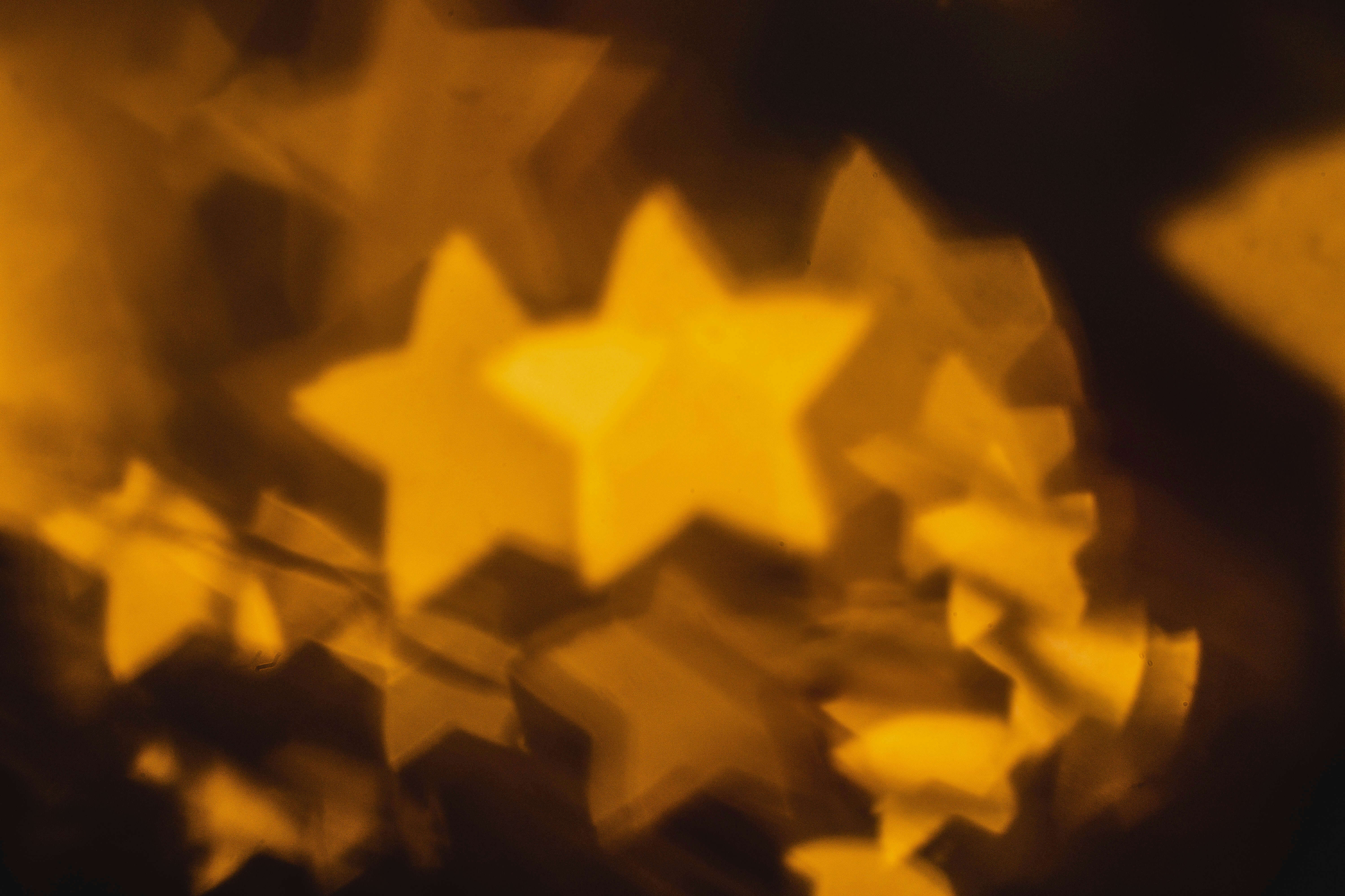 a photo of orange stars lying in a pile with ones in the distance barely visible
