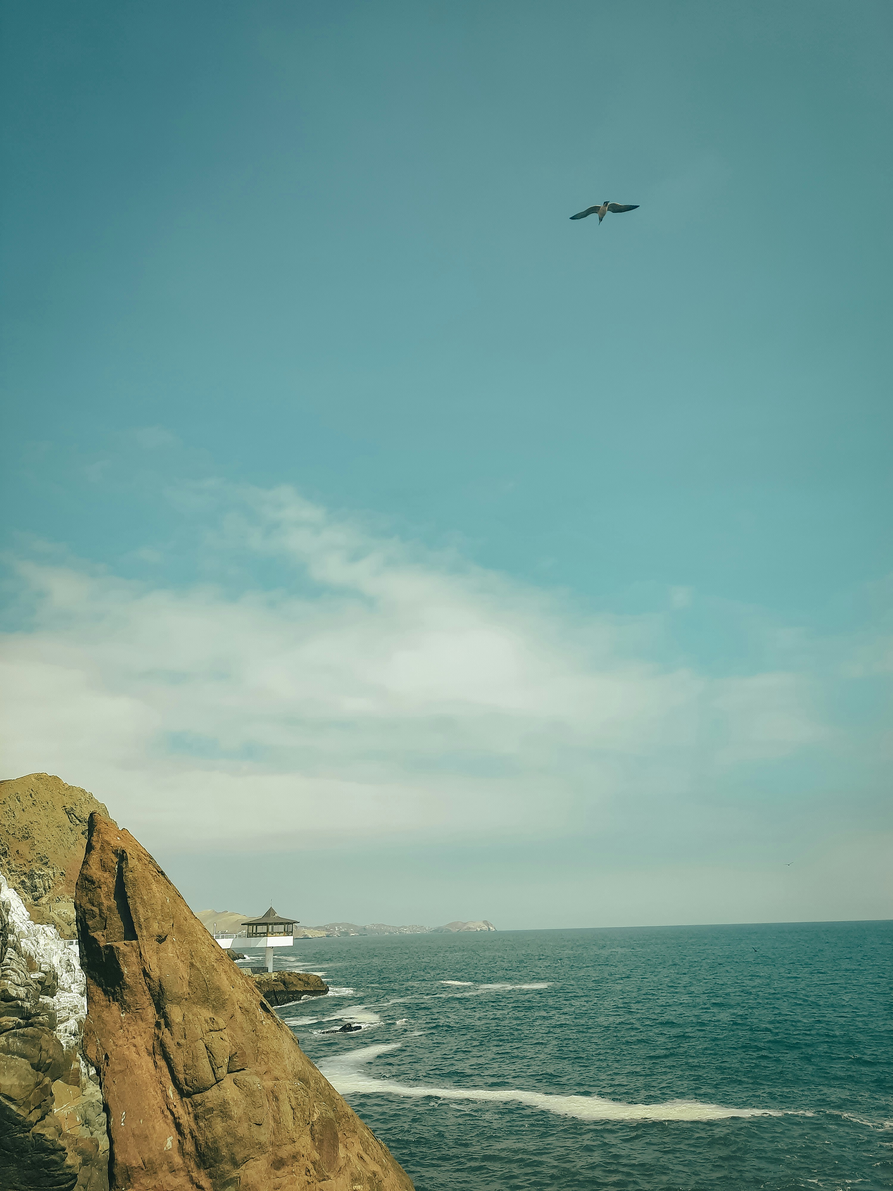 a photo of a costal rocky cliff at mid day