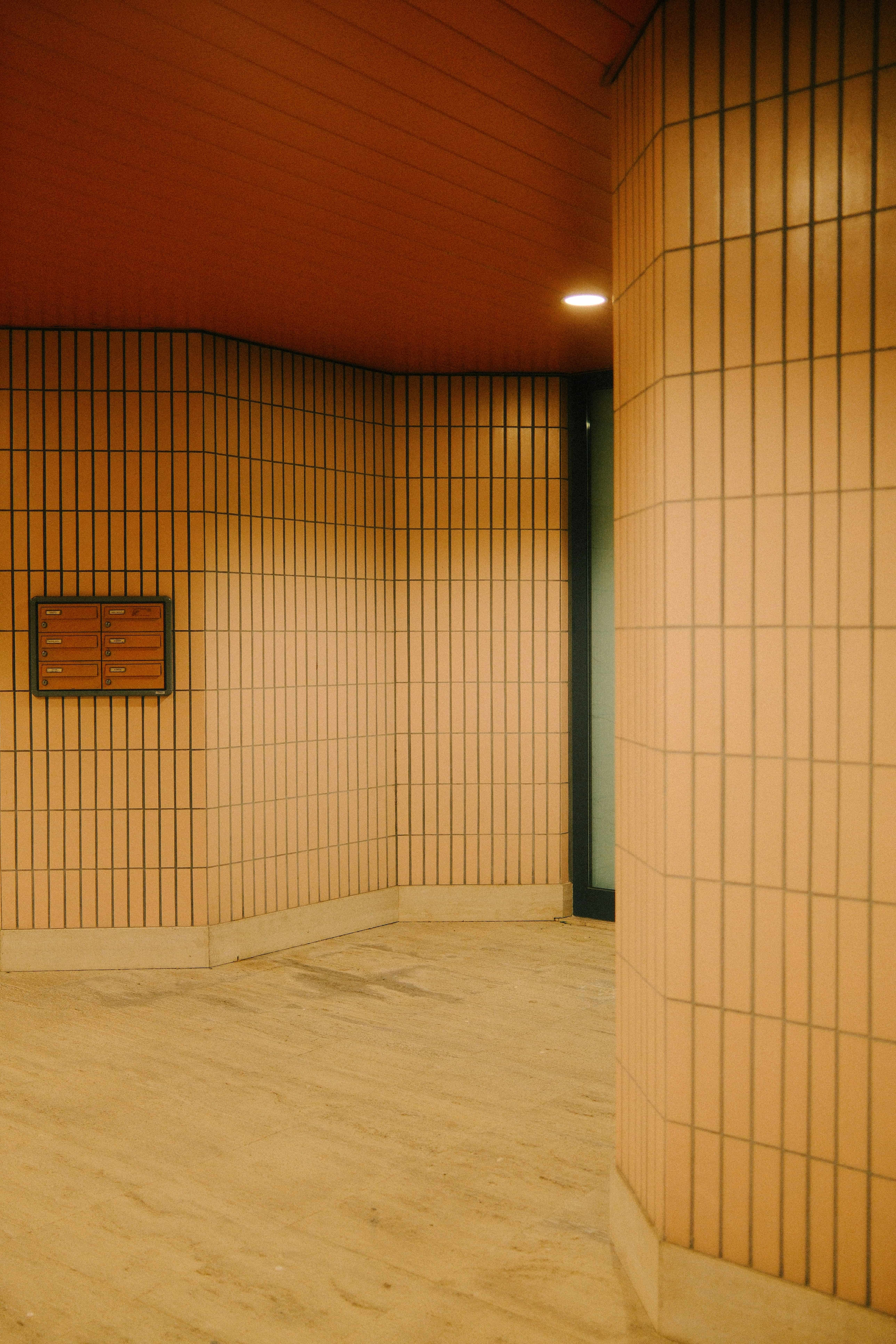 a photo of a orange tinted coridor inside a building