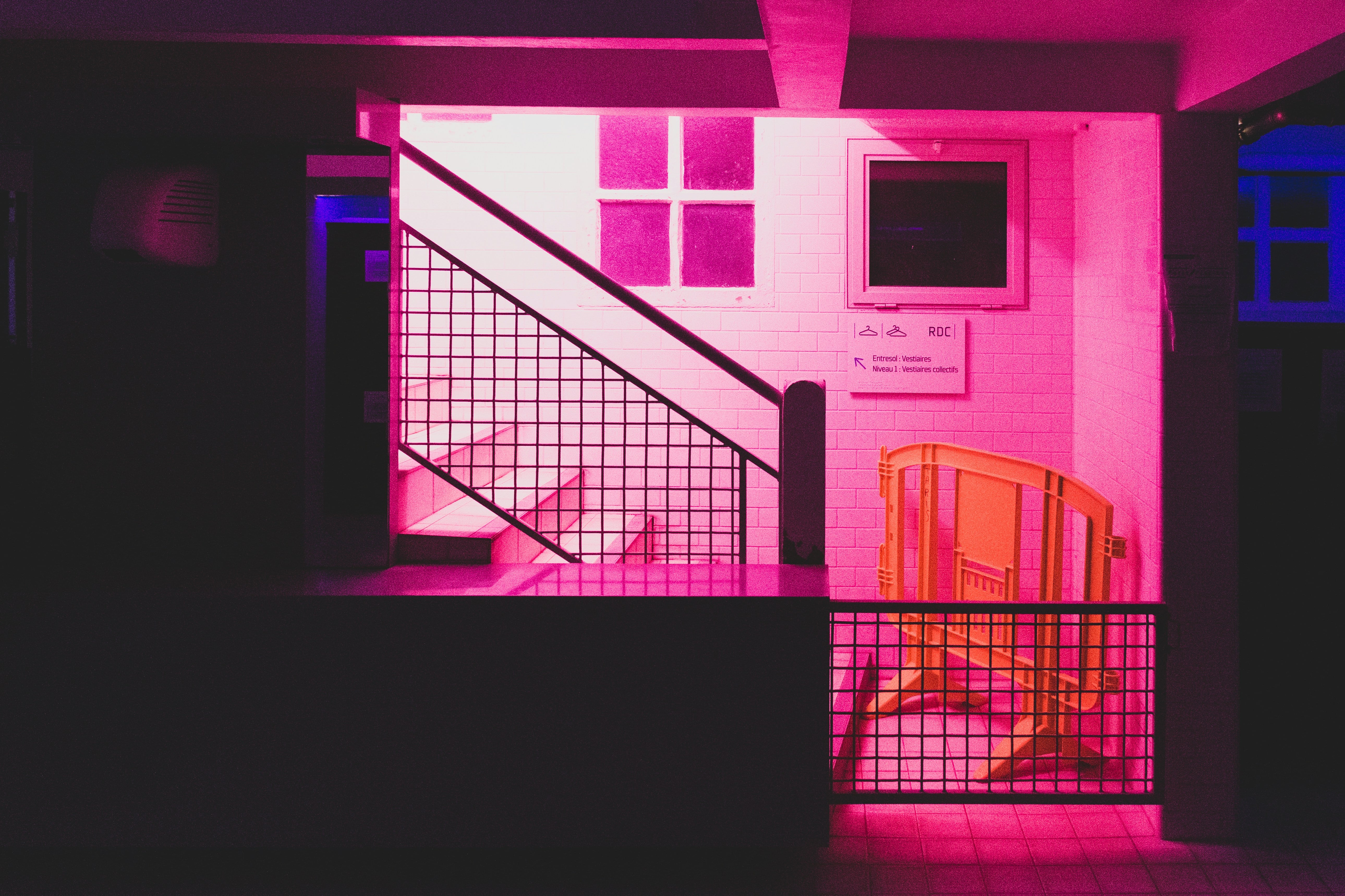 a photo of a starwell from the side lit by bright neon pink
