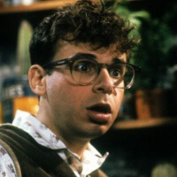 a screenshot of seymour from little shop of horrors infront of a shelf of plants