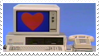 An old beige desktop with a red heart on the screen and a blue background